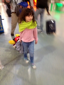 little girl with a suitcase in an airport