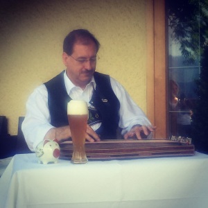 This picture of a traditionally-dressed man serenading hotel guests was taken at breakfast, at 0900. Notice the beer?